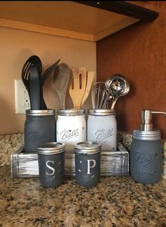 kitchen utensils and spoons are sitting on the counter