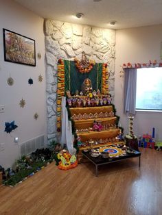 there is a small shrine in the corner of this room with many decorations on it