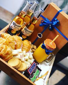 a wooden box filled with snacks and drinks