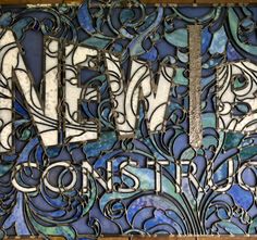 an old stained glass window with the word new construction written in silver letters on it