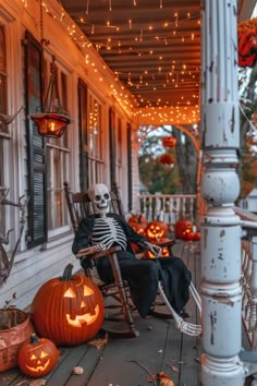 a skeleton sitting in a rocking chair on a porch decorated with pumpkins and lights