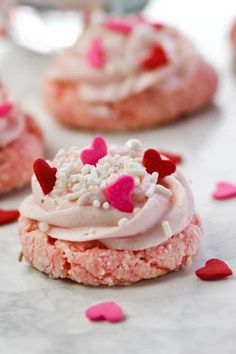 pink cookies with white frosting and hearts on them