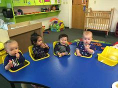 four children sitting at a table eating food