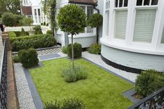 an outdoor garden with grass, shrubs and trees