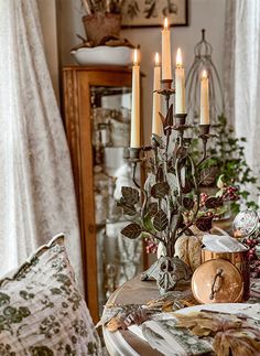 a dining room table with candles on it