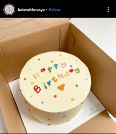 a birthday cake in a box with the words happy birthday written on it