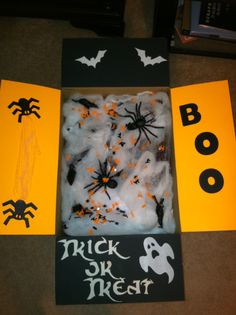 a trick or treat made out of foam and paper with fake bats, spider webs, and spooky eyes