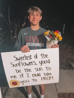 a young man holding a sign that says sweetest of the sunflowers, you'd be the sun to me if i could take you to pron