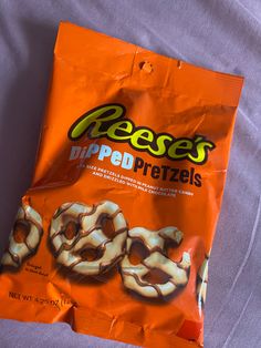 a bag of pretzels sitting on top of a bed