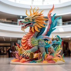 a colorful dragon statue sitting in the middle of a building