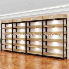 an empty room with wooden shelves and lights on the wall, in front of a potted plant