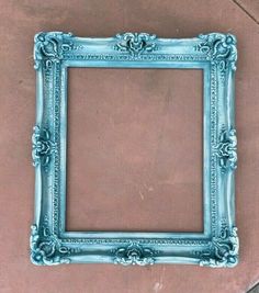 an old blue frame sitting on the ground