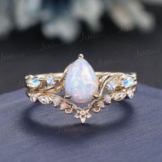 Nature Inspired  Jewelry, Twig Opal Ring Set , 10K Gold, Teardrop Ring, Branch Engagement Ring, Moonstone Wedding Ring , October Birthstone, Birthday Gifts Main Ring : 6*8mm Pear cut Lab white opal. Side stone : Moonstone Matching Band: Moissanite and opal. Material Metal: 925 sterling silver, Solid 14k/18k gold, platinum PLEASE choose silver or platinum if you are allergic to nickel. This jewelry is made to order, it can be made with any gemstone/metals. 2-3 weeks to finish. Default Shipping me Sun Ring Engagement, Fairy Wedding Ring Opal, Opal Ring Set, Opal And Aquamarine Ring, Mythical Engagement Ring, Fine Jewelry Teardrop Moonstone Wedding Ring, Wedding Fine Jewelry Teardrop Moonstone Ring, Teardrop Moonstone Wedding Ring Fine Jewelry, Teardrop Moonstone Wedding Ring In Fine Jewelry Style