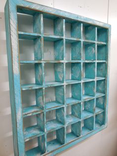 an old blue book shelf with many compartments