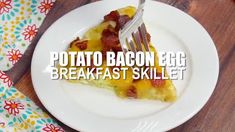 a piece of bacon egg breakfast skillet on a white plate with a fork in it