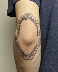 a man with a tattoo on his arm has a circular frame in the middle of it