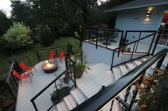 an outdoor deck with chairs and fire pit