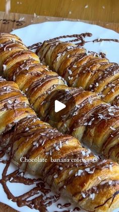 chocolate banana croissants on a white plate drizzled with icing