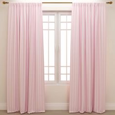 a pink curtain hanging in front of a window