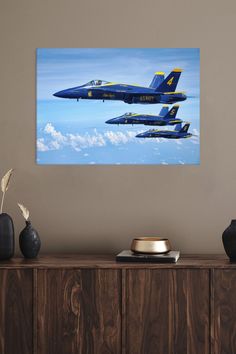 two blue fighter jets flying in the sky above clouds canvas wall art print on wood