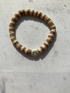 Brown/tan smile bracelet for 3.00$ Brown Preppy Bracelets, Neutral Color Clay Bead Bracelet, Beige Clay Bead Bracelets, Clay Bead Bracelet Ideas Neutral Colors, Brown Clay Bead Bracelet Ideas, Brown Bracelet Ideas, Brown Clay Bead Bracelet, Brown Beaded Bracelets, Preppy Brown