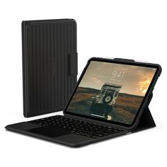 an open laptop computer sitting on top of a desk next to a black tablet case