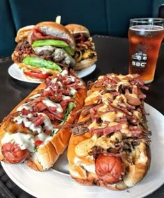 two hot dogs on buns with toppings and a beer