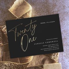 a black and gold foiled business card with the words twenty one printed on it