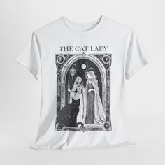 Embrace your mystical side with this Spooky Cat Lady T-shirt, featuring a tarot card-inspired graphic. Perfect for fans of witchy vibes and feline friends, this design blends a touch of the mystical with a stylish, spooky flair--ideal for Halloween or any time you want to showcase your love for cats and the occult. This is the perfect mystical outfit for the childless cat lady! FEATURES .: Classic fit ensures comfy, relaxed wear while the crew neckline adds that neat, timeless look that can blen Tarot Graphic, Witchcraft Clothing, Spooky Cat, Witchy Vibes, Cat Lady, Halloween Shirt, Graphic Tees, Bathing Beauties, Adult Outfits