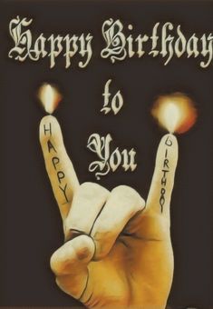 a happy birthday card with a hand holding two lit candles in the shape of a peace sign