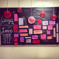 a bulletin board covered in lots of different types of paper decorations and writing on it