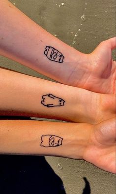 two people with matching tattoos on their arms