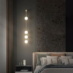 a bed with three lights hanging from it's headboard next to a night stand