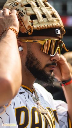 a baseball player wearing a catchers mitt and sunglasses