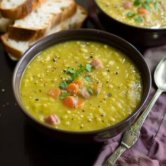 two bowls filled with soup next to slices of bread