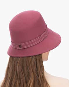 A fashionable women's cloche hat is hand-blocked of the finest superfelt, and then trimmed with a contrast stitch matching band of the same. The ultra sleek silhouette features a rakishly downturned brim, bringing focus to the eyes while framing the face beautifully. Brim span center front: 2.75"(7cm) side: 3"(7.5cm) Designed and finished in the USA Hand-blocked by skilled artisans Sustainable wool and cashmere blend superfelt Elasticized sweatband Adjustable head-size with hidden velcro® featur Fitted Fur Felt Cloche Hat With Flat Brim, Fall Cloche Hat With Short Brim In Fur Felt, Fall Wide Brim Fur Felt Cloche Hat, Chic Wide Brim Solid Color Cloche Hat, Wool Hat Bands For Fall, Fur Felt Cloche Hat With Short Brim For Fall, Fitted Cloche Hat With Curved Brim, Fitted Solid Cloche Hat, Fitted Solid Color Cloche Hat