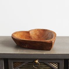 a wooden bowl sitting on top of a table