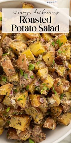 roasted potato salad with herbs in a white bowl