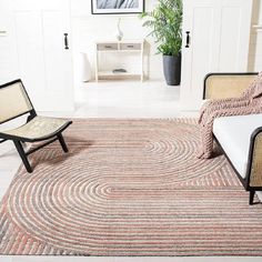 a living room with two chairs and a rug