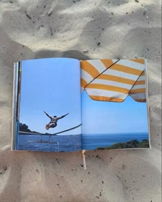 an open book on the beach with a photo of a person doing acrobatic tricks