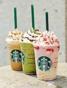 three starbucks drinks with whipped cream and toppings