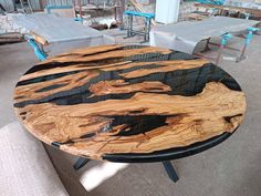 a wooden table sitting on top of a floor next to two couches and tables