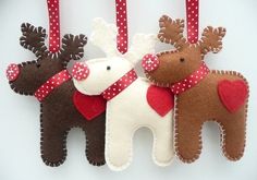 three reindeer ornaments hanging on a wall