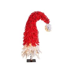 a red and white christmas decoration on a stand