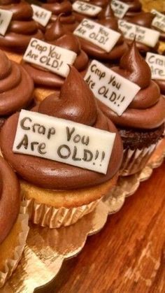 cupcakes with chocolate frosting and writing on them that say crap you are old