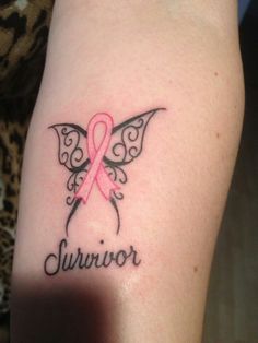 a woman's arm with a pink ribbon on it and the word survivor written in black ink