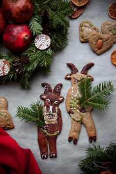 some cookies are decorated like animals and pine cones