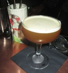 a drink sitting on top of a wooden table