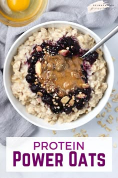 a bowl filled with oatmeal topped with peanut butter and blueberries