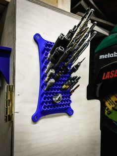 there is a blue rack with many tools in it